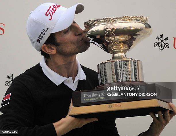 Gregory Bourdy of France kisses the winner's trophy after his victory in the Hong Kong Open golf tournament at the Hong Kong Golf Club in Fanling on...