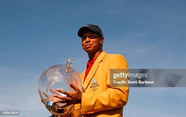 Tiger Woods of the USA poses with the trophy after the final round of the 2009 Australian Masters at Kingston Heath Golf Club on November 15, 2009 in...