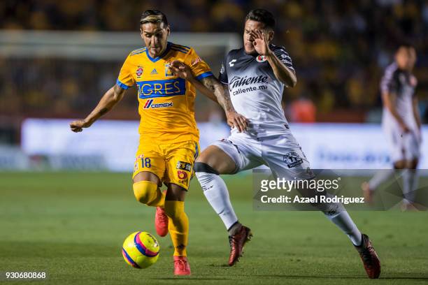 Ismael Sosa of Tigres fights for the ball with Hiram Muñoz of Tijuana during the 11th round match between Tigres UANL and Tijuana as part of the...