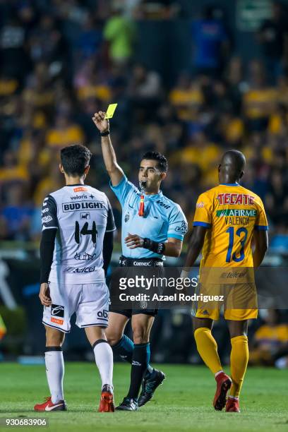 Referee Adonai Escobedo gives a yellow card to Alejandro Guido of Tijuana during the 11th round match between Tigres UANL and Tijuana as part of the...