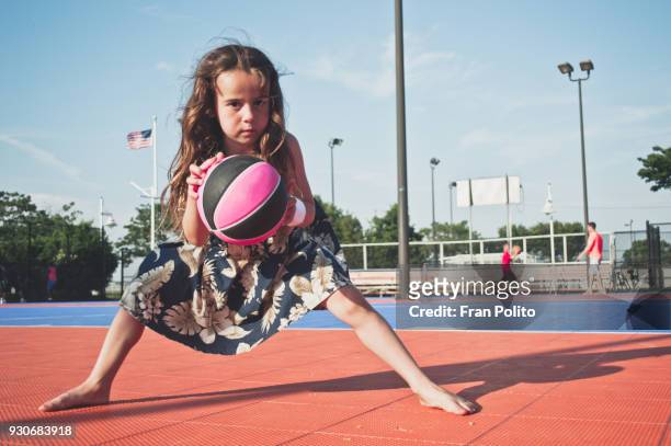 A girl playing basketball.