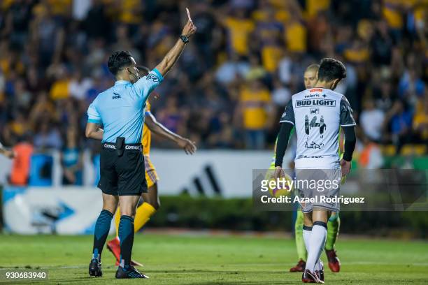 Referee Adonai Escobedo gives a red card to Alejandro Guido of Tijuana during the 11th round match between Tigres UANL and Tijuana as part of the...