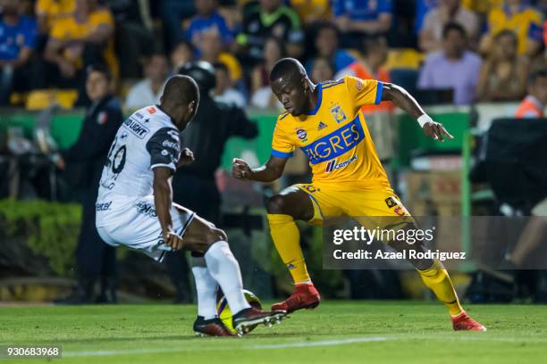 Enner Valencia of Tigres fights for the ball with Julio Angulo of Tijuana during the 11th round match between Tigres UANL and Tijuana as part of the...