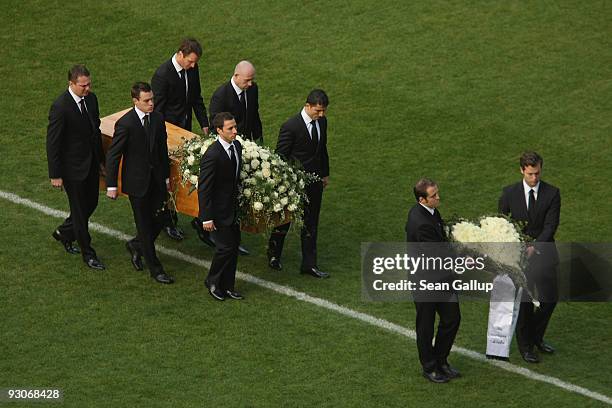 Members of the Hannover 96 football club carry the coffin of their goalie Robert Enke at a memorial service prior to Enke's funeral at AWD Arena on...