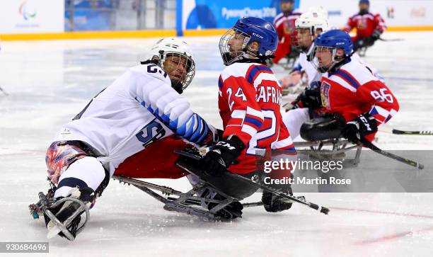 Rico Roman of United States cashes into Zdenek Safranek of Czech Republic in the Ice Hockey Preliminary Round - Group B game between United States...