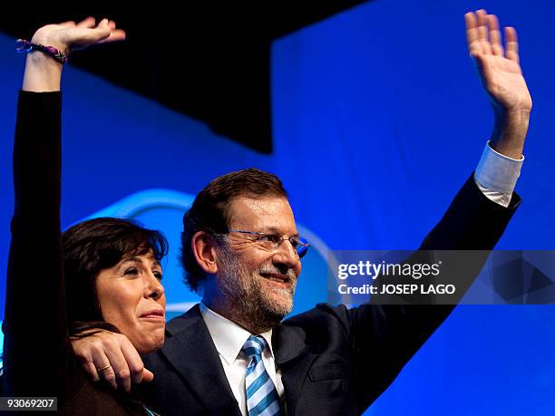 The leader of the opposition Spanish Popular Party , Mariano Rajoy , and the president of the Catalan PP, Alicia Sanchez Camacho , wave during the...