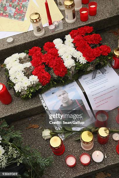 Flowers arranged into the name "Enke" lie among a sea of candles and flowers in tribute to Hannover 96 goalkeeper Robert Enke at the conclusion of a...