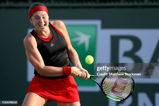 Jelena Ostapenko of Latvia plays Petra Martic of Croatia during the BNP Paribas Open at the Indian Wells Tennis Garden on March 11, 2018 in Indian...