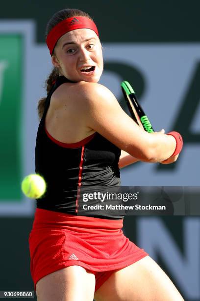 Jelena Ostapenko of Latvia plays Petra Martic of Croatia during the BNP Paribas Open at the Indian Wells Tennis Garden on March 11, 2018 in Indian...