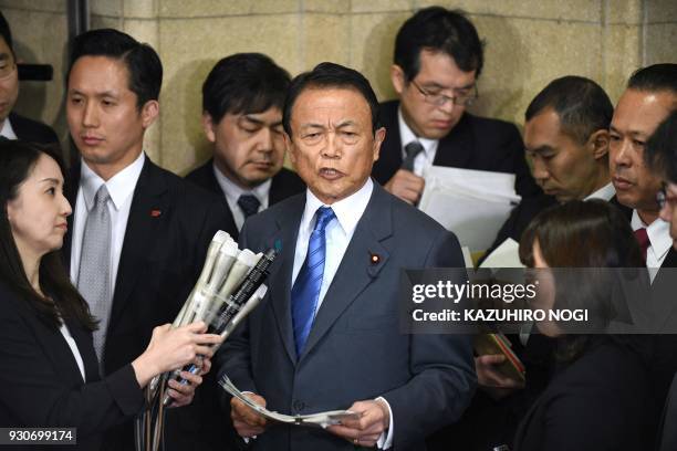 Japan's Finance Minister Taro Aso answers questions during a press briefing at the finance ministry in Tokyo on March 12, 2018. - Japan's finance...