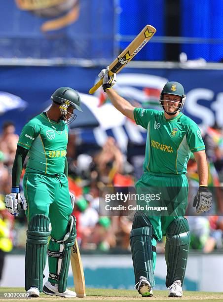 Graeme Smith captain of South Africa celebrates reaching his 50 with team mate Loots Bosman during the 2nd Twenty20 international match between South...