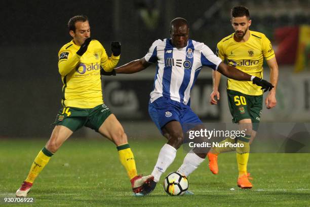 Porto's Cameroonian forward Vincent Aboubakar vies with Pacos Ferreira's Portuguese midfielder Ruben Micael and Pacos Ferreira's Portuguese forward...