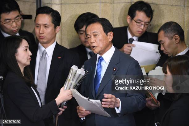 Japan's Finance Minister Taro Aso answers questions during a press briefing at the finance ministry in Tokyo on March 12, 2018. Japan's finance...