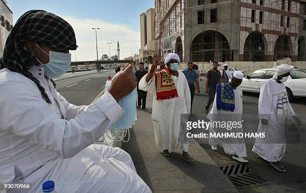 Man sells medical masks for Muslim pilgrims near the Prophet Mohammed Mosque in the Saudi holy city of Medina on November 13, 2009. More than three...