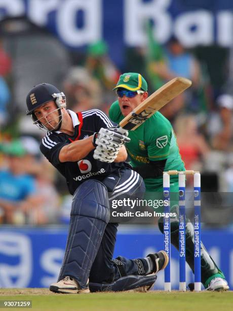 Jonathan Trott of England hits a boundary as Heino Kuhn of South Africa looks on during the 2nd Twenty20 international match between South Africa and...