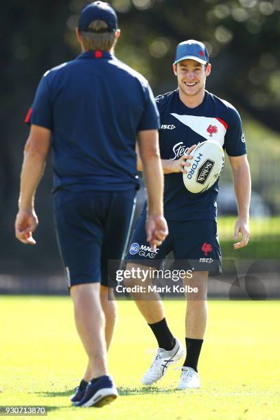 Luke Keary shares a joke with Roosters head coach Trent Robinson during a Sydney Roosters Training Session at Kippax Oval on March 12, 2018 in...