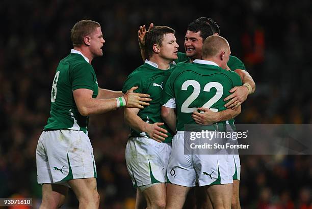Brian O'Driscoll of Ireland is congratulated by team mates after scoring a last minute try during the Rugby Union International between Ireland and...
