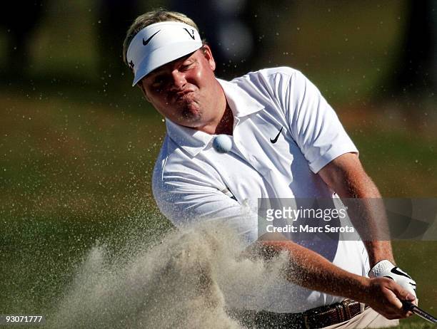 Carl Pettersson of Sweden hits out of the sand trap on the first hole during the final round at the Children's Miracle Network Classic at Disney's...