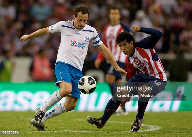 Edgar Mejia of Chivas vies for the ball with Gerardo Torrado of Cruz Azul during their match as part of the 2009 Opening tournament, the closing...