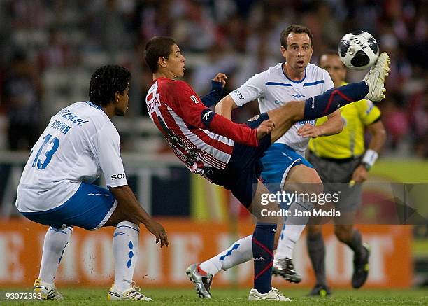 Javier Hernandez of Chivas vies for the ball with Gerardo Torrado of Cruz Azul during their match as part of the 2009 Opening tournament, the closing...