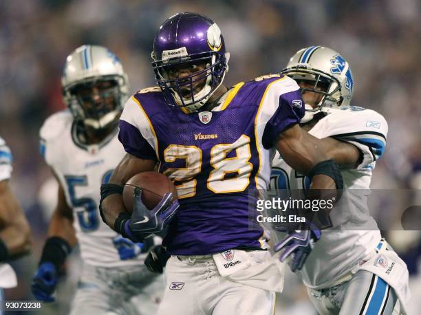 Adrian Peterson of the Minnesota Vikings carries the ball as Phillip Buchanon of the Detroit Lions defends on November 15, 2009 at Hubert H. Humphrey...