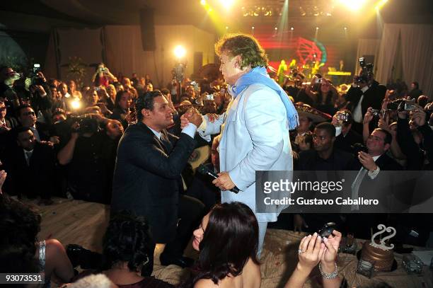 Former MLB player Sammy Sosa goes on the table to greet Juan Gabriel that just performed for Sammy Sosa's birthday party at Fontainebleau Miami Beach...