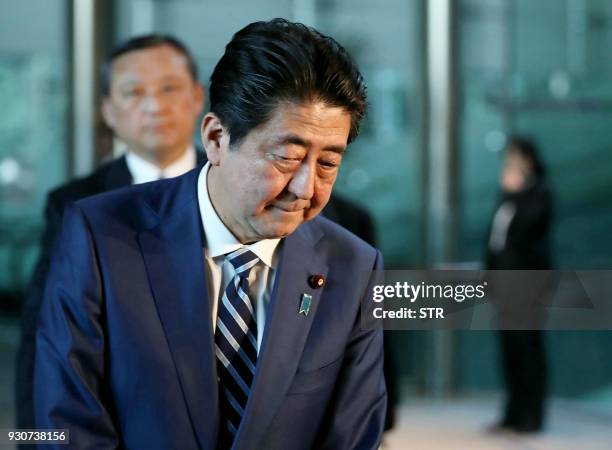 Japan's Prime Minister Shinzo Abe appears before journalists at his office in Tokyo on March 12, 2018. Finance Minister Taro Aso admitted to...