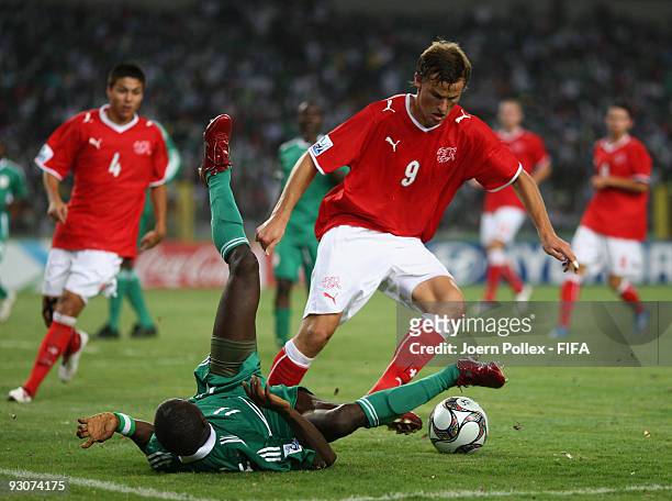 Terry Envoh of Nigeria and Haris Seferovic battle for the ball during the FIFA U17 World Cup Final between Switzerland and Nigeria at the Abuja...