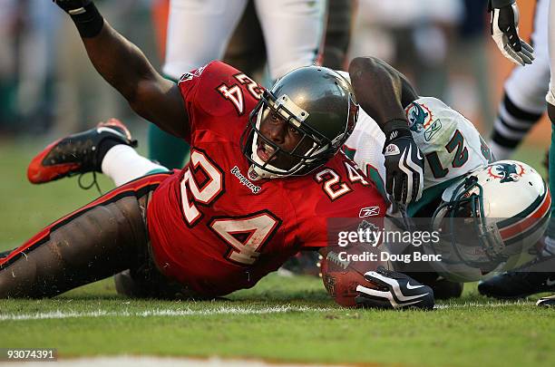 Running back Carnell Williams of the Tampa Bay Buccaneers celebrates his fourth quarter touchdown after getting past cornerback Vontae Davis of the...