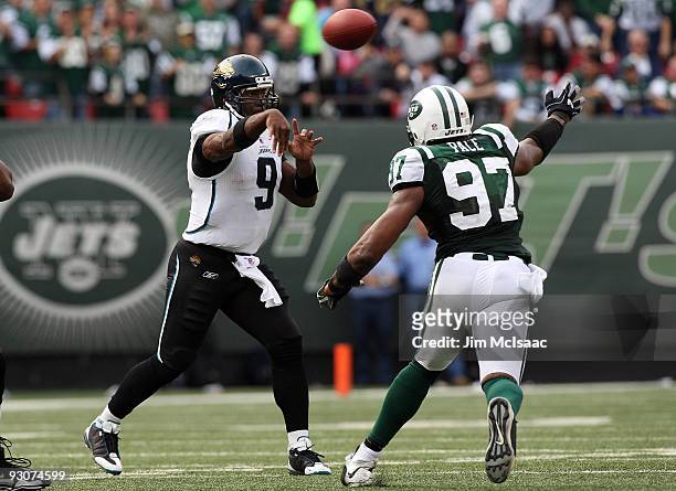 David Garrard of the Jacksonville Jaguars throws a pass against Calvin Pace the New York Jets on November 15, 2009 at Giants Stadium in East...