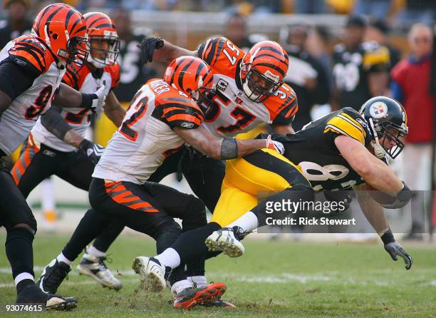 Heath Miller of the Pittsburgh Steelers tries to escape the tackle of Chris Crocker and Dhani Jones of the Cincinnati Bengals at Heinz Field on...
