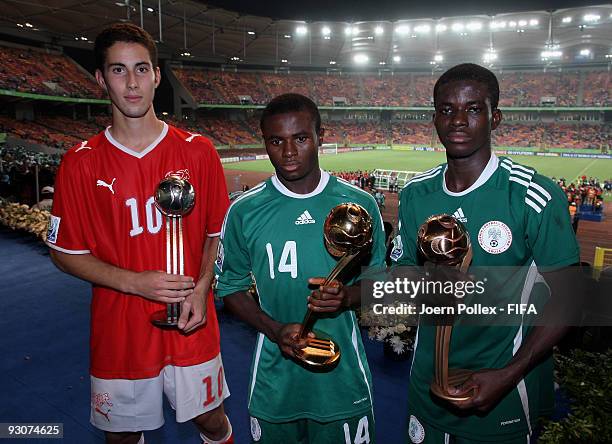 Fortune Chukwudi and Sani Emmanuel of Nigeria and Nassim Ben Khalifa of Switzerland pose with the Ball Trophies after the FIFA U17 World Cup Final...