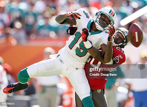 Cornerback Ronde Barber of the Bay Buccaneers prevents a reception by wide receiver Ted Ginn Jr. #19 of the Miami Dolphins at Land Shark Stadium on...