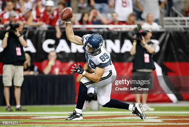 John Carlson of the Seattle Seahawks celebrates a touchdown by spiking the ball in the first half against the Arizona Cardinals at University of...