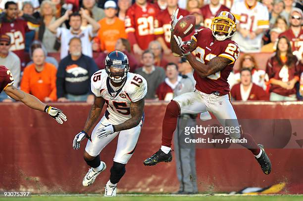 DeAngelo Hall of the Washington Redskins makes an interception of a pass intended for Brandon Marshall of the Denver Broncos at FedExField on...