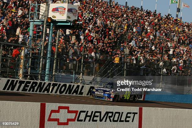 Jimmie Johnson, driver of the Lowe's Chevrolet, takes the checkered flag to win the NASCAR Sprint Cup Series Checker O'Reilly Auto Parts 500 at...