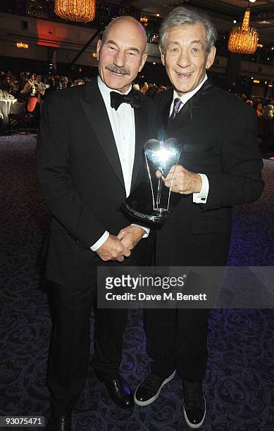 Actors Patrick Stewart and Sir Ian McKellen, recipient of The Bernard Delfont Award for Outstanding Contribution to Showbusiness, pose during the...