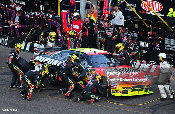 Jeff Gordon, driver of the Dupont Chevrolet, makes a pit stop during the NASCAR Sprint Cup Series Checker O'Reilly Auto Parts 500 at Phoenix...