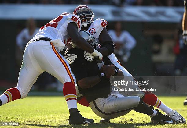 Wallace Gilberry and Tamba Hali of the Kansas City Chiefs sack JaMarcus Russell of the Oakland Raiders during an NFL game at Oakland-Alameda County...