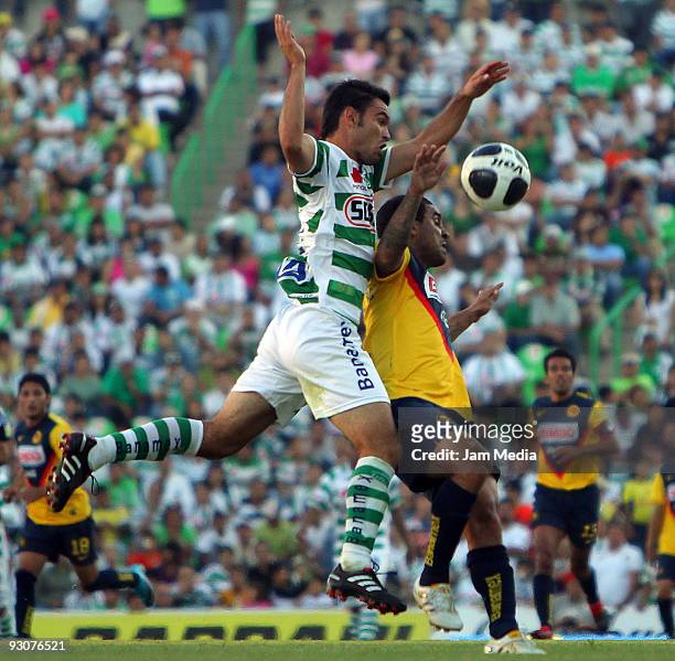 Christian Sanchez of Santos Laguna vies for the ball with Adolfo Rosinei of Aguilas del America during their match as part of the Apertura 2009...