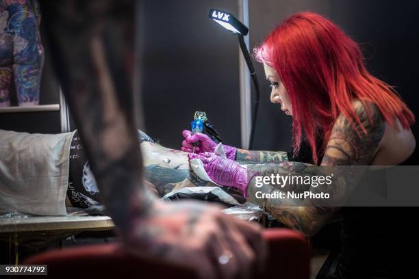 Man receives a tattoo during the Paris Tattoo Convention on March 10, 2018 at the Grand Halle de la Villette in Paris. The 8th edition of the Mondial...