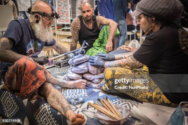 Man receives a tattoo during the Paris Tattoo Convention on March 10, 2018 at the Grand Halle de la Villette in Paris. The 8th edition of the Mondial...