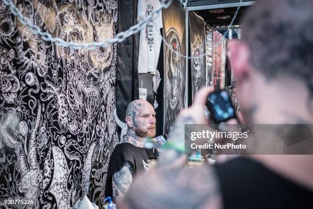 Man with tattoo poses during the Paris Tattoo Convention on March 10, 2018 at the Grand Halle de la Villette in Paris. The 8th edition of the Mondial...