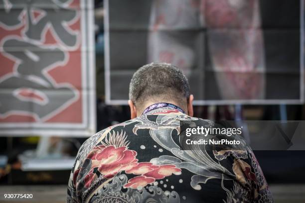 Man receives a tattoo during the Paris Tattoo Convention on March 10, 2018 at the Grand Halle de la Villette in Paris. The 8th edition of the Mondial...