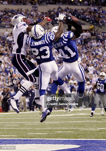 Antoine Bethea of the Indianapolis Colts makes an interception in the endzone next to Tim Jennings during the third quarter against the New England...