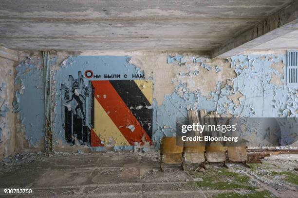 Decaying Soviet era mosaics sit on a wall inside an abandoned building in the evacuated city of Pripyat, Ukraine, on Wednesday, Feb. 28, 2018. Solar...