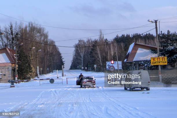 Police checkpoint blocks a road leading through forest to the Chernobyl nuclear power plant in Chernobyl, Ukraine, on Wednesday, Feb. 28, 2018. Solar...