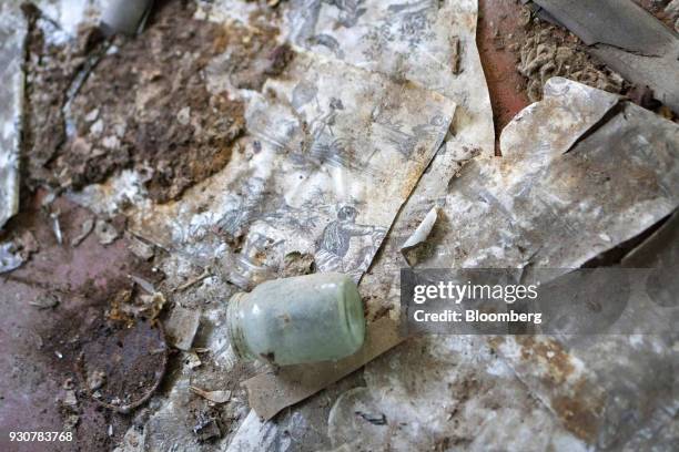 Decaying personal items sit on the floor of a house abandoned following the Chernobyl nuclear reactor meltdown in the evacuated city of in Pripyat,...