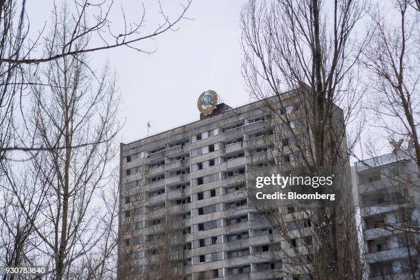 Soviet symbol sits above an abandoned residential block in the evacuated city of in Pripyat, Ukraine, on Wednesday, Feb. 28, 2018. Solar Chernobyl...