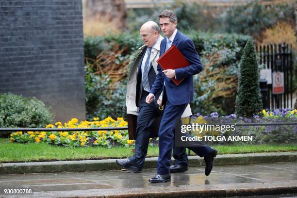Britain's Air Chief Marshall Stuart Peach and Britain's Defence Secretary Gavin Williamson arrive in Downing Street in central London on March 12...